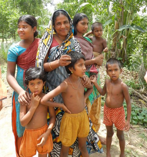 Sabera Talukder takes a photo of a family outside of Dhaka, Bangladesh.