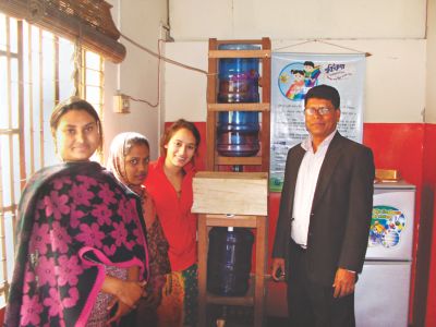 Sabera Talukder installing her water purification system in daycares for street children in Dhaka, Bangladesh.